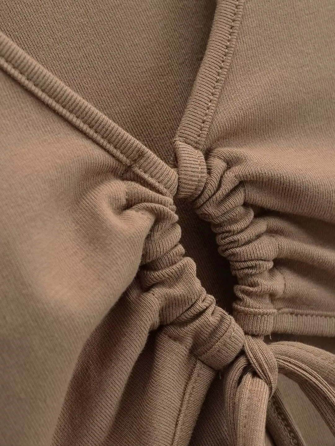 A long shirt with a circle tie in the stomach
