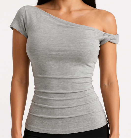 A shirt with a falling shoulder and shirring at the waist