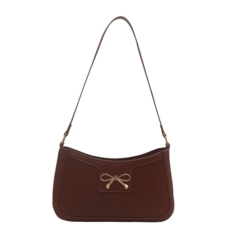 Shoulder bag with gold bow