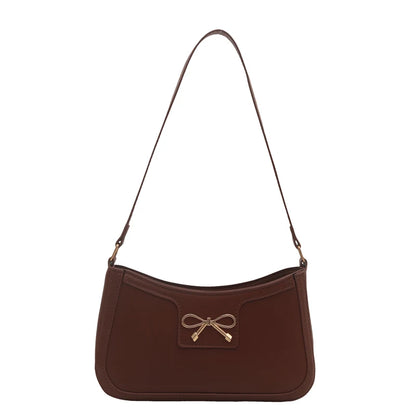 Shoulder bag with gold bow