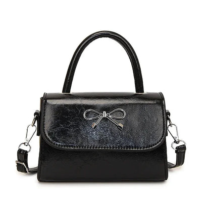 Hand/shoulder bag with bow tie