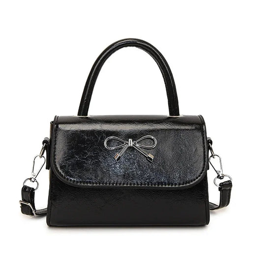 Hand/shoulder bag with bow tie