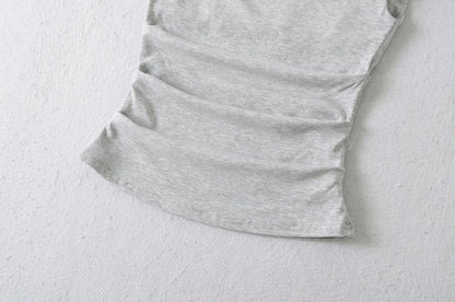 A shirt with a falling shoulder and shirring at the waist