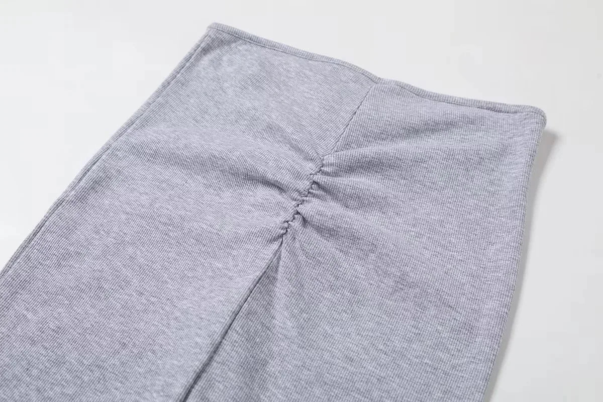 A tight long skirt with a gathered buttock and a front tie