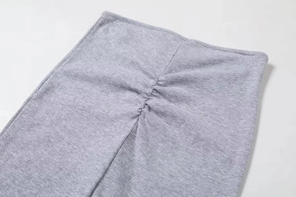 A tight long skirt with a gathered buttock and a front tie
