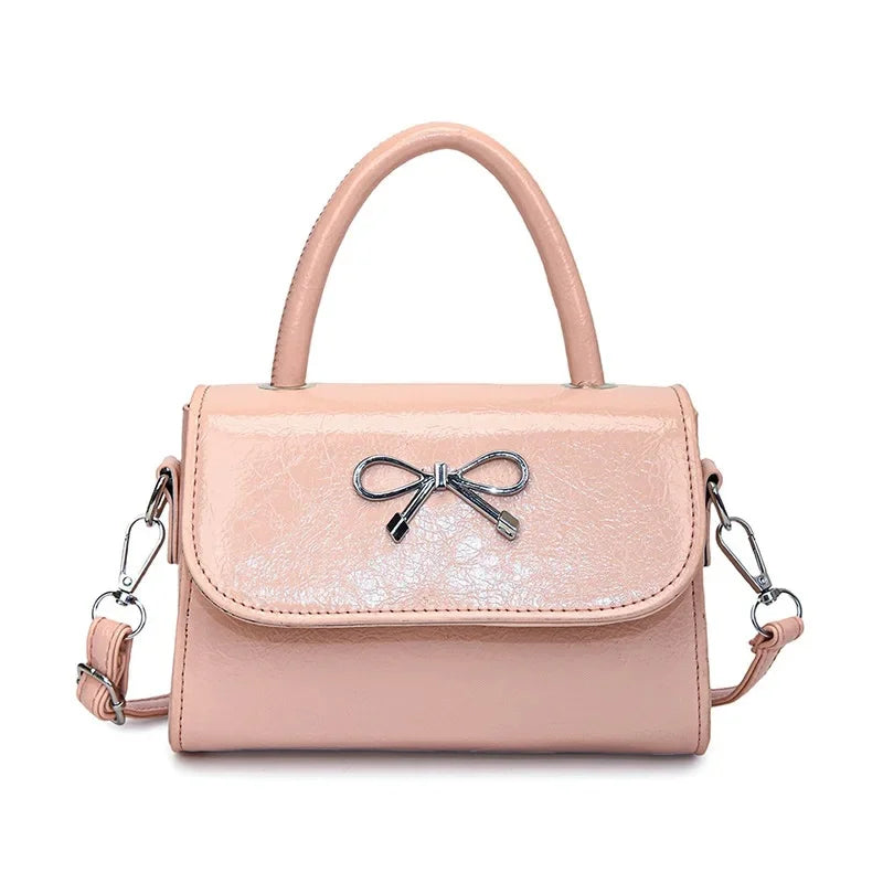 Hand/shoulder bag with bow tie