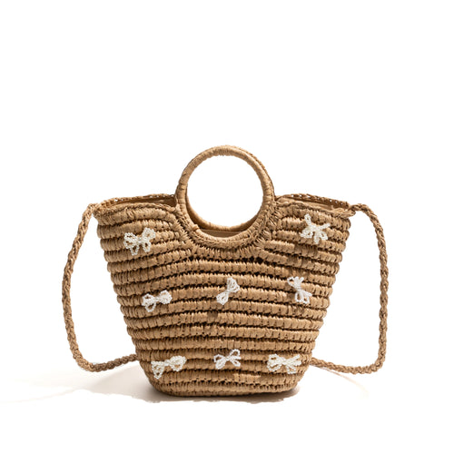 A large straw bag with ribbons