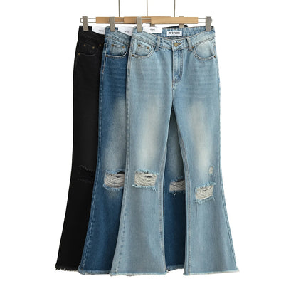 Flared jeans with rips at the knees