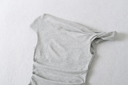 A shirt with a falling shoulder and shirring at the waist