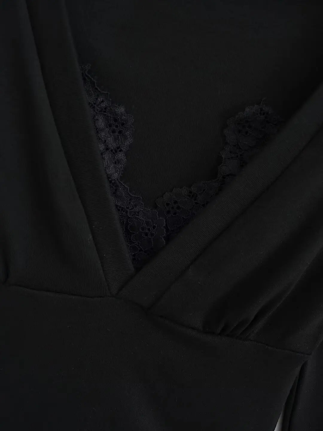 A long shirt with a neckline and protruding lace