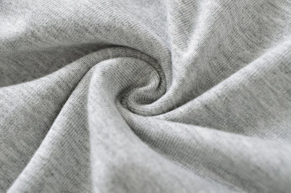 A shirt with a falling shoulder and shirring at the waist