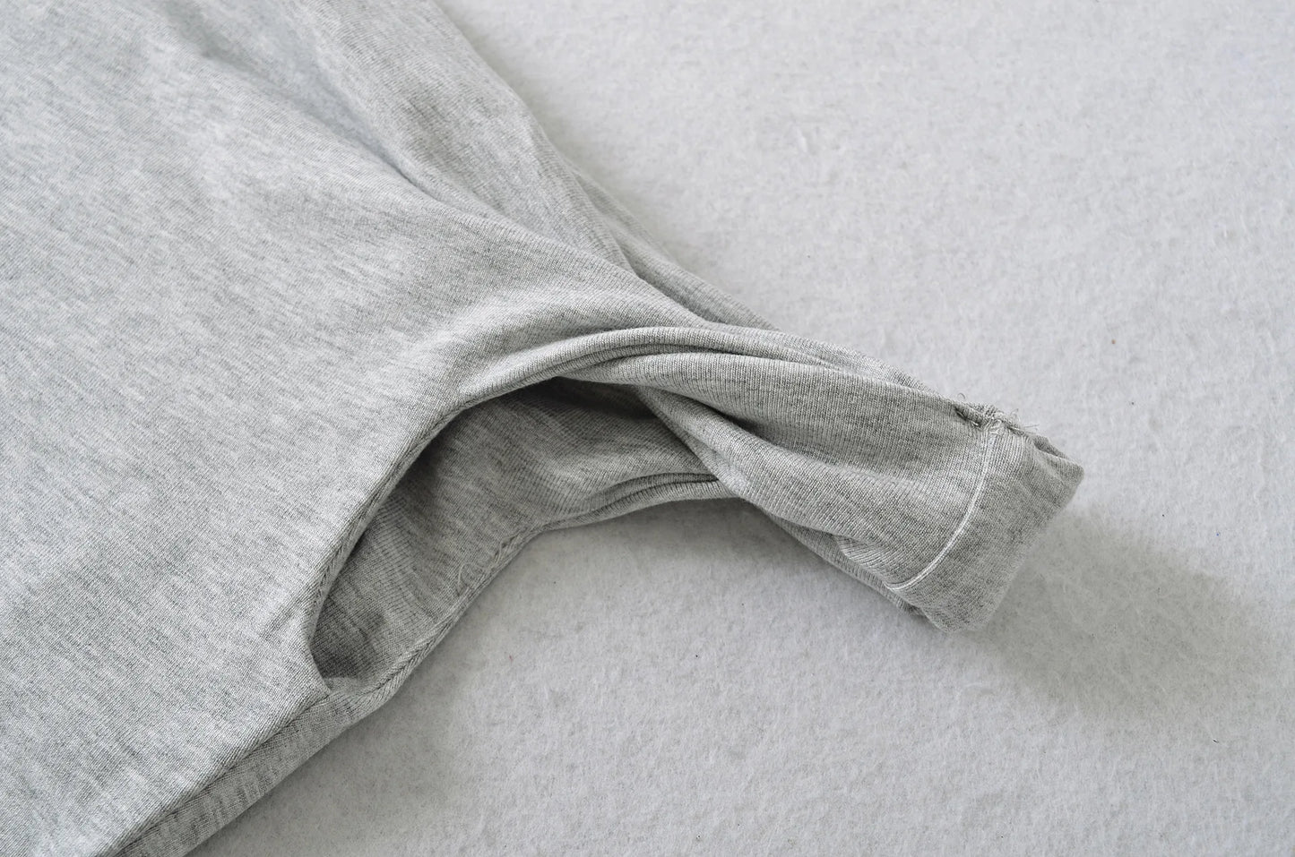 A shirt with a falling shoulder and shirring at the waist