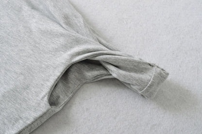 A shirt with a falling shoulder and shirring at the waist