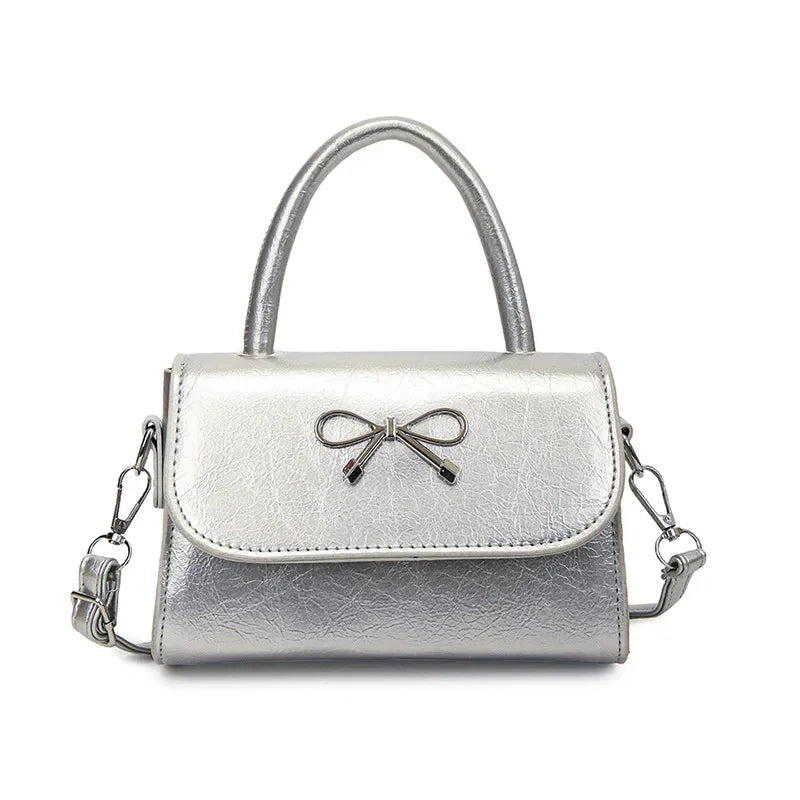 Hand/shoulder bag with bow tie
