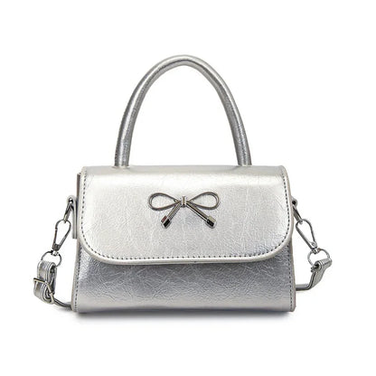 Hand/shoulder bag with bow tie