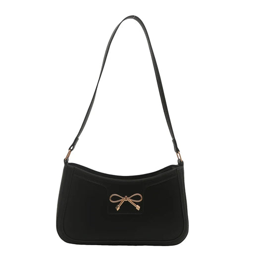 A shoulder bag with a gold-colored bow