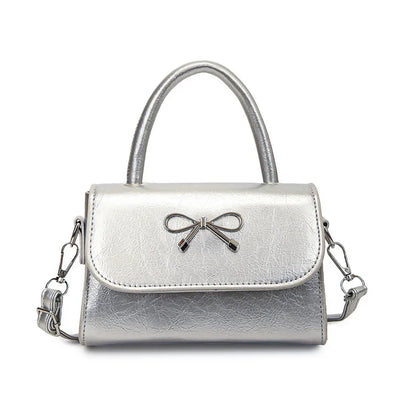 Hand/shoulder bag with bow tie