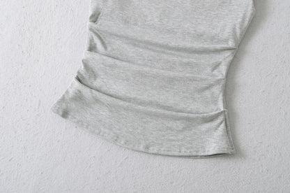 A shirt with a falling shoulder and shirring at the waist